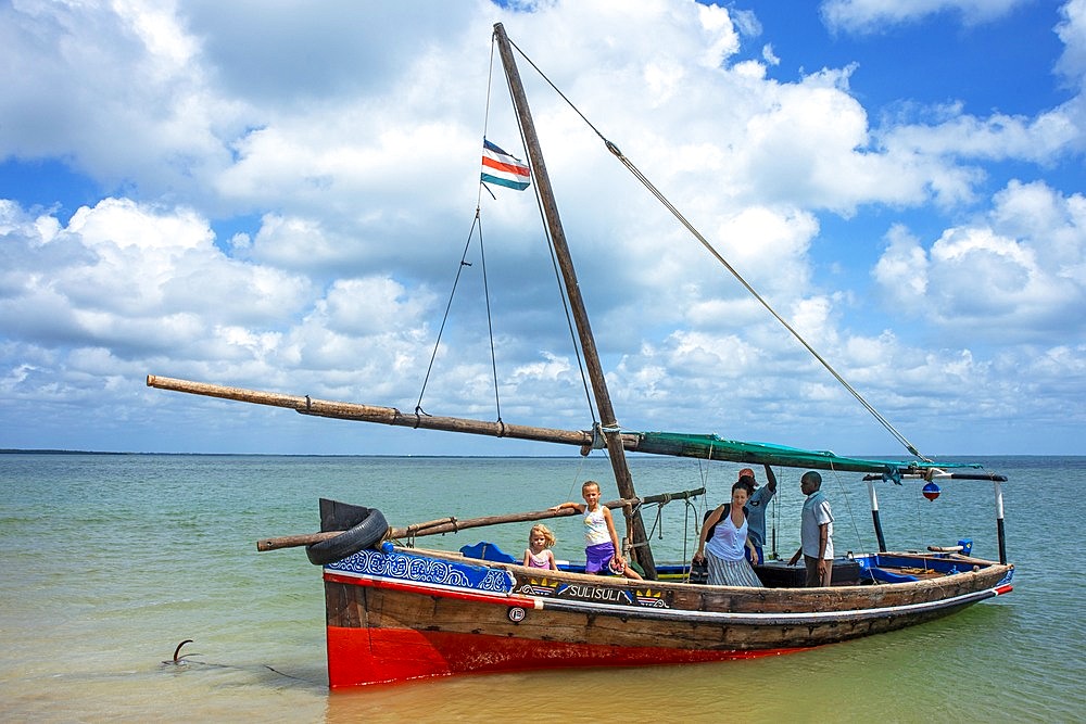 Tourists european family inside a dhow sailing boat in Manda island in Lamu archipelago in Kenya