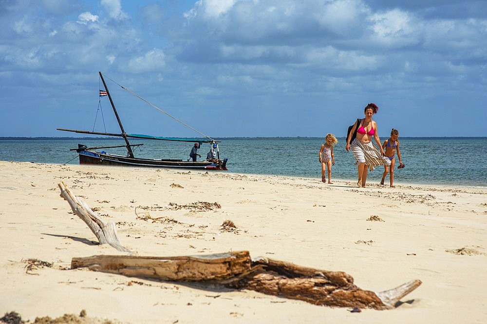 European Tourist family on the white beach in Manda island in Lamu archipelago in Kenya