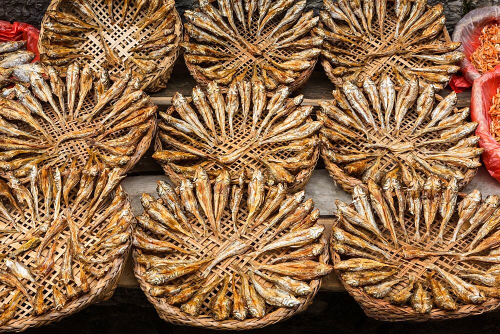 Baskets of dried fish for sale on the street in the ancient town of Furong, China.