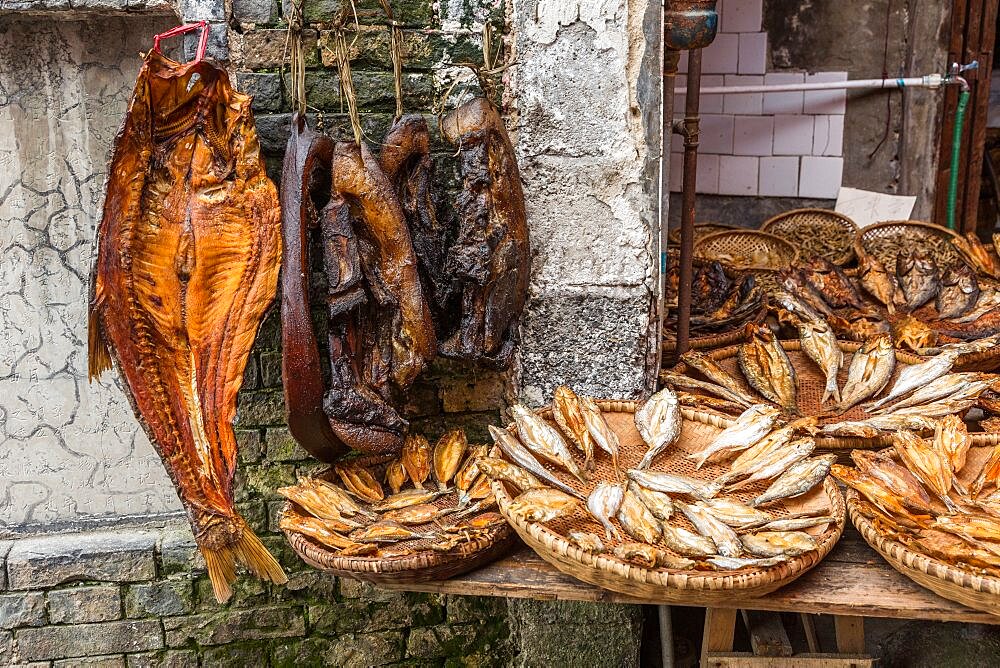 Smoked bacon and dried fish for sale in an open-air street market in Furong, China.