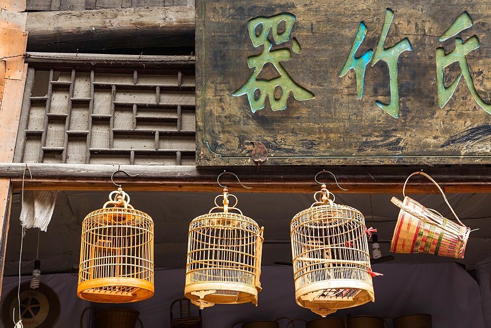 Split bamboo birdcages on display for sale on the street in the ancient town of Furong, Hunana, China.