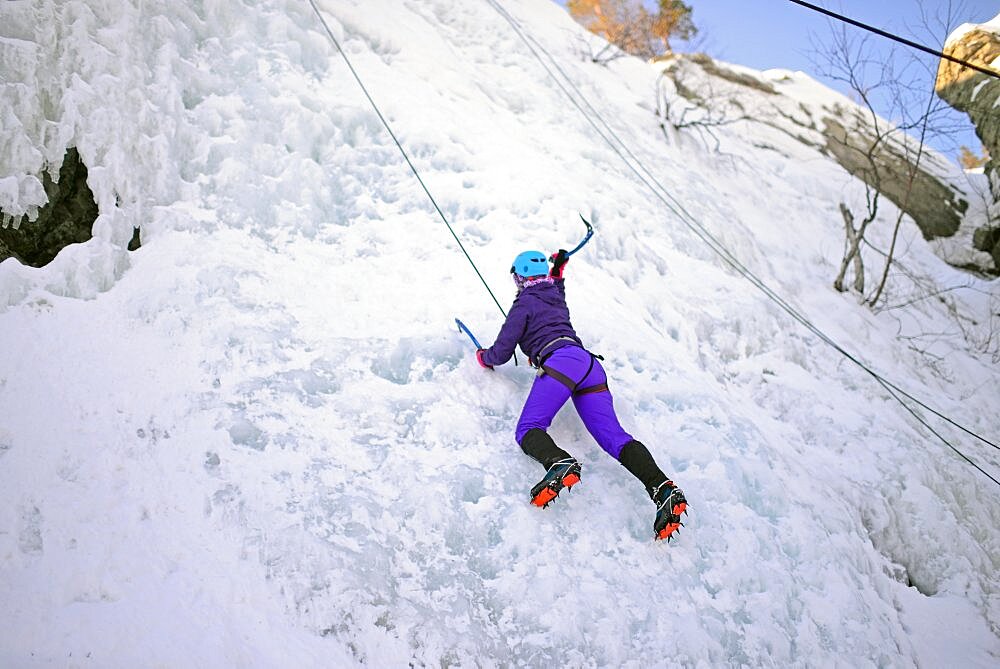 Young woman ice climbing in Pyha, Lapland, Finland