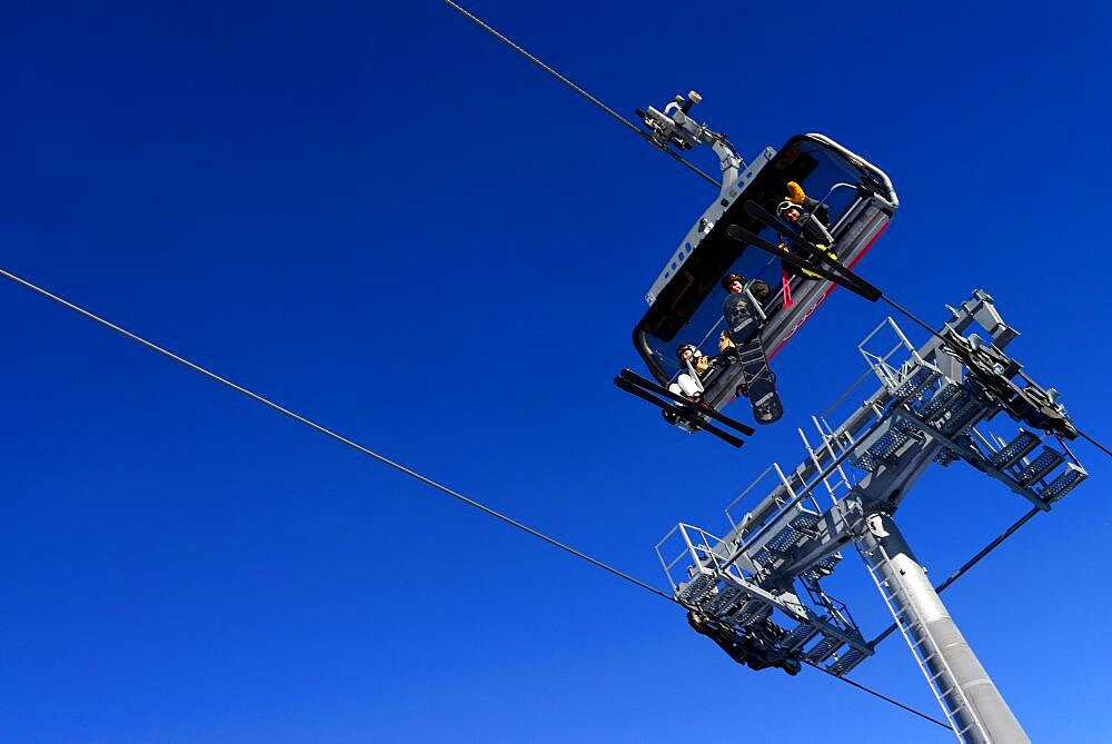 Skiers say hi from chair lift. Pyha Ski Resort in Lapland, Finland