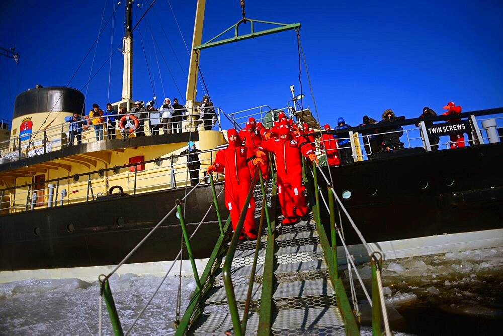 Swimming in the frozen sea during Sampo Icebreaker cruise, an authentic Finnish icebreaker turned into touristic attraction in Kemi, Lapland