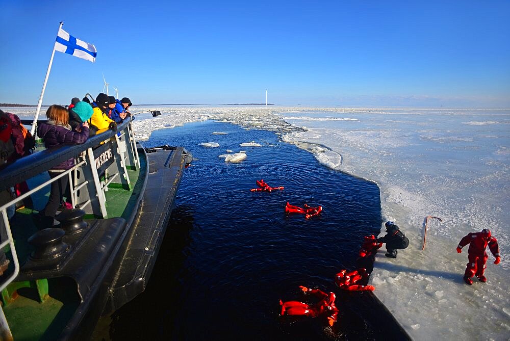 Swimming in the frozen sea during Sampo Icebreaker cruise, an authentic Finnish icebreaker turned into touristic attraction in Kemi, Lapland