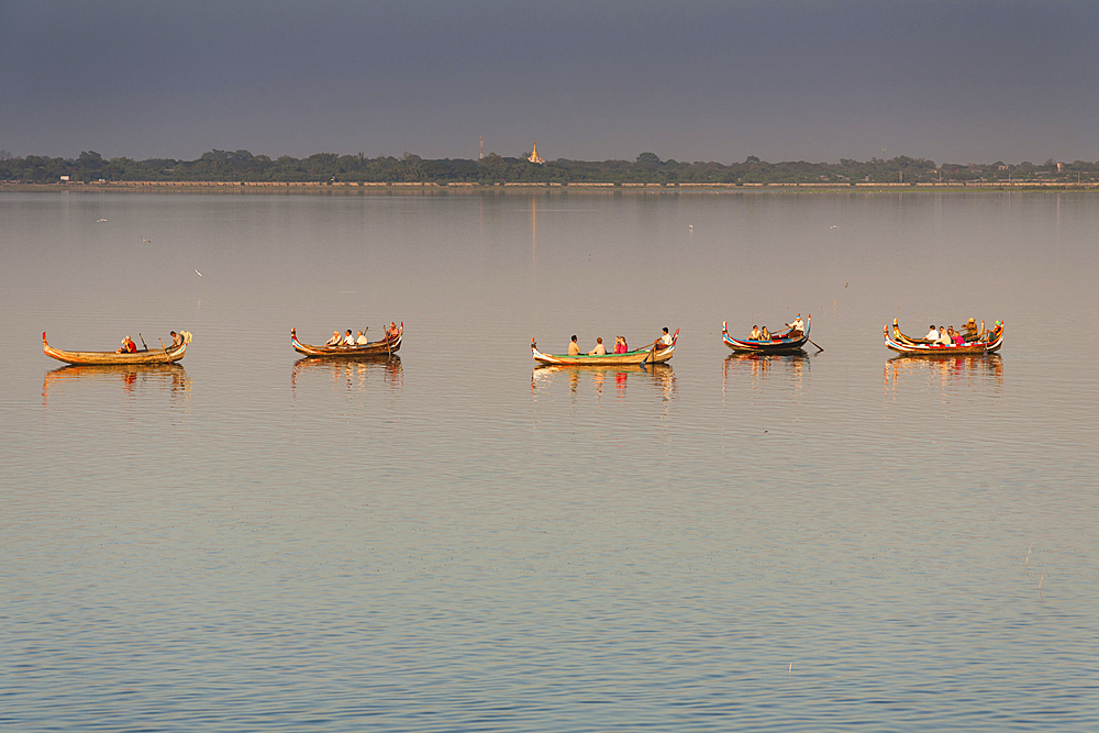 Boats transporting tourists on Taungthaman Lake, Amarapura, Mandalay, Myanmar, (Burma)