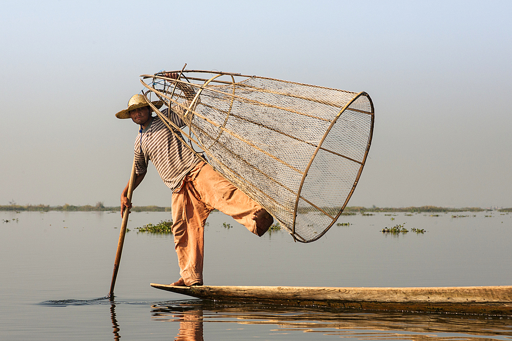 Intha fisherman holding traditional fishing net, Inle Lake, Nyaung Shwe, Shan State, Myanmar, (Burma)