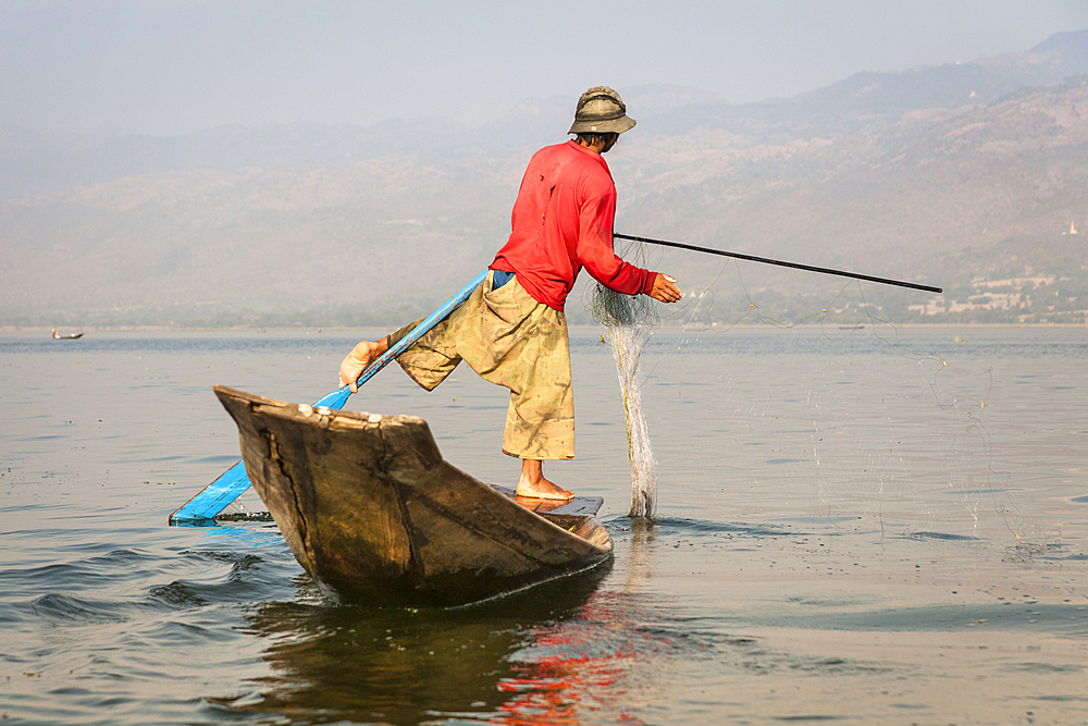 Intha fisherman fishing in a traditional fishing boat, Inle Lake, Nyaung Shwe, Shan State, Myanmar, (Burma)