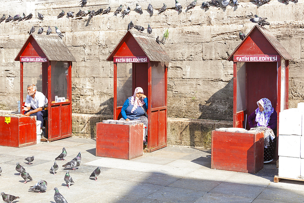 People selling food for pigeons at the New Mosque, Eminonu Yeni Camii, Eminonu, Istanbul, Turkey