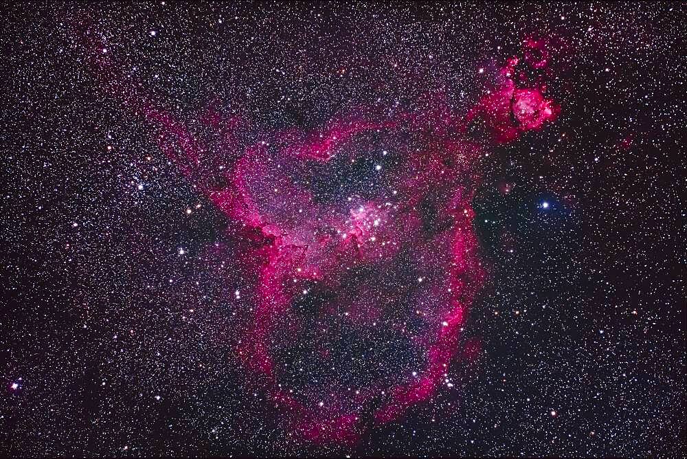 The large emission nebula IC 1805 in Cassiopeia, aka the Heart Nebula. The round nebula at top right is NGC 896. The large loose star cluster at centre is Mel 15; the star cluster at left is NGC 1027. The small cluster below NGC 896 is Tombaugh 4.