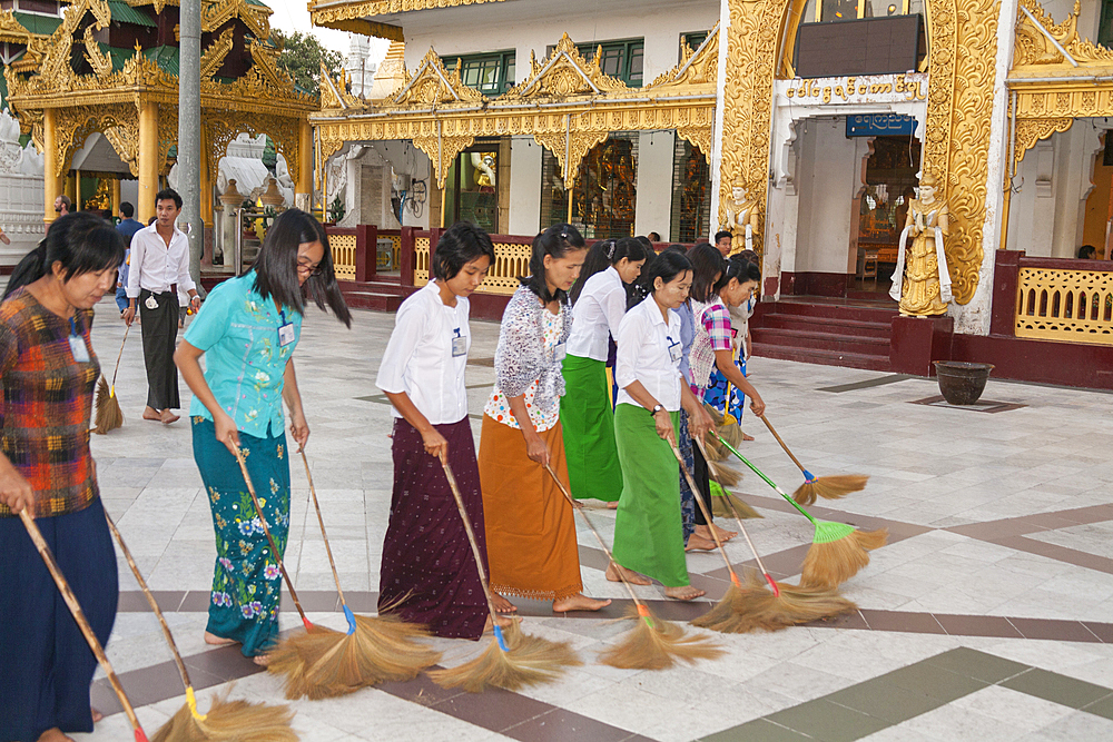 Women sweeping tiled floor at Shwedagon Pagoda, Yangon, (Rangoon), Myanmar, (Burma)