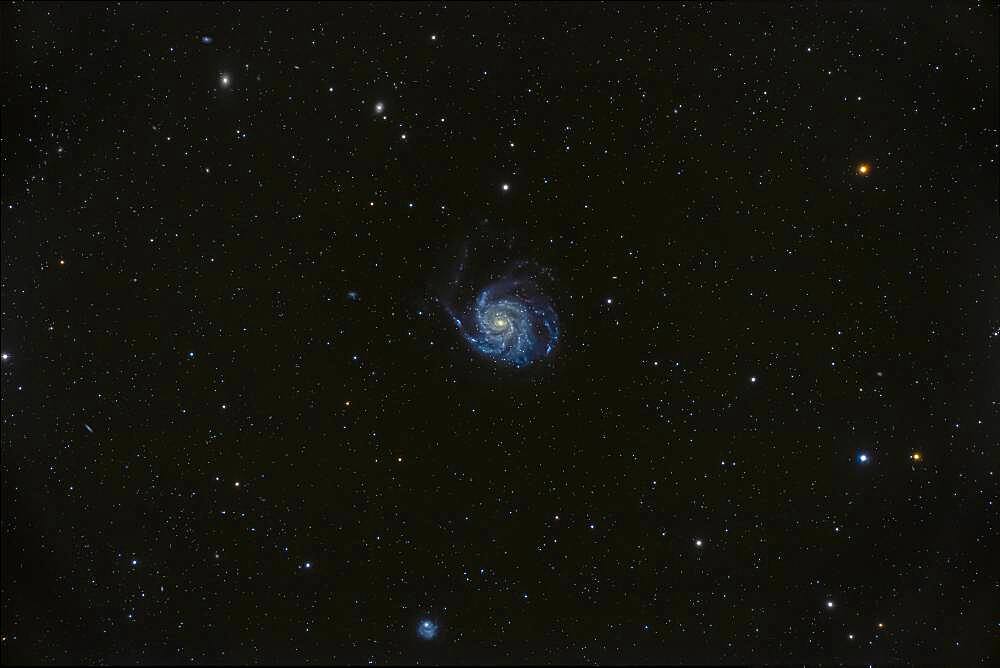 Messier 101, the Pinwheel Galaxy in Ursa Major, a classic face-on spiral galaxy, large and obvious in binoculars.  The odd galaxy at bottom is NGC 5474.