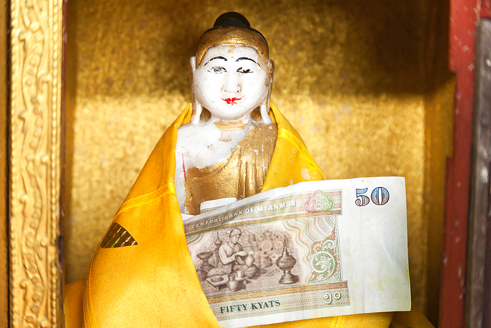 Religious statue and donation at Popa Taung Kalat Temple, Mount Popa, near Bagan, Myanmar, (Burma)