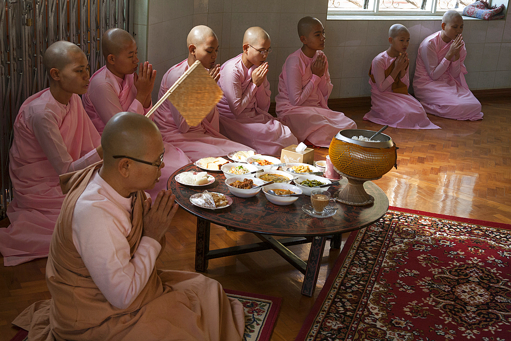 Nuns praying before eating, Sakyadhita Thilashin Nunnery School, Sagaing, near Mandalay, Myanmar, (Burma)