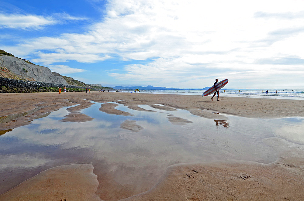 Surfers on Cote des Basques beach at sunset, Biarritz