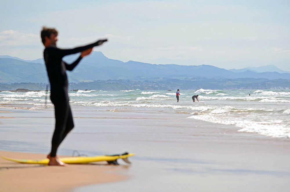 Surfers on Cote des Basques beach at sunset, Biarritz