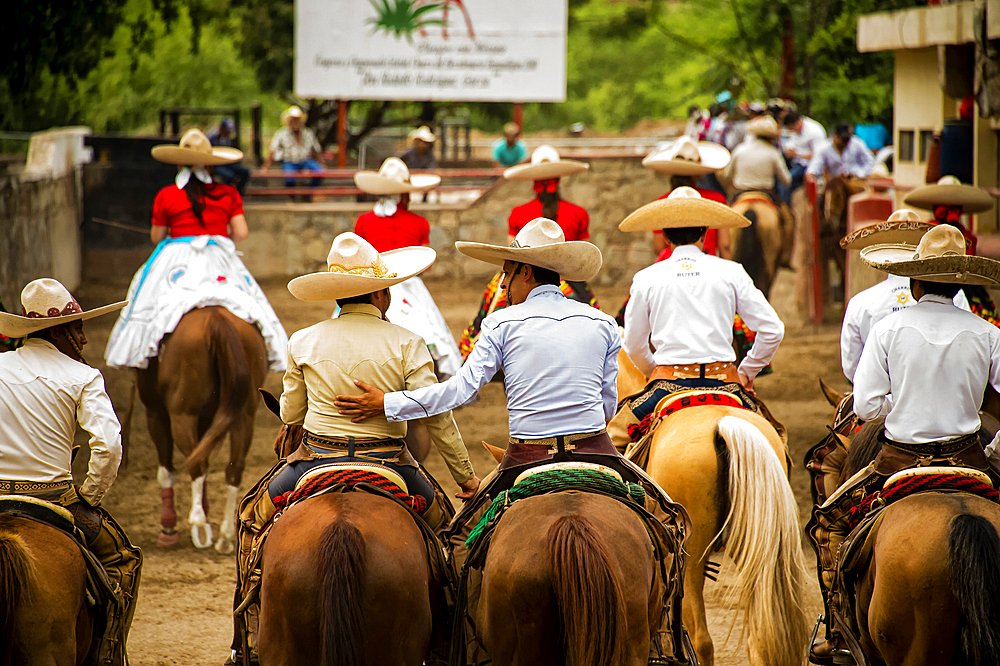 Two charros greeting each other,