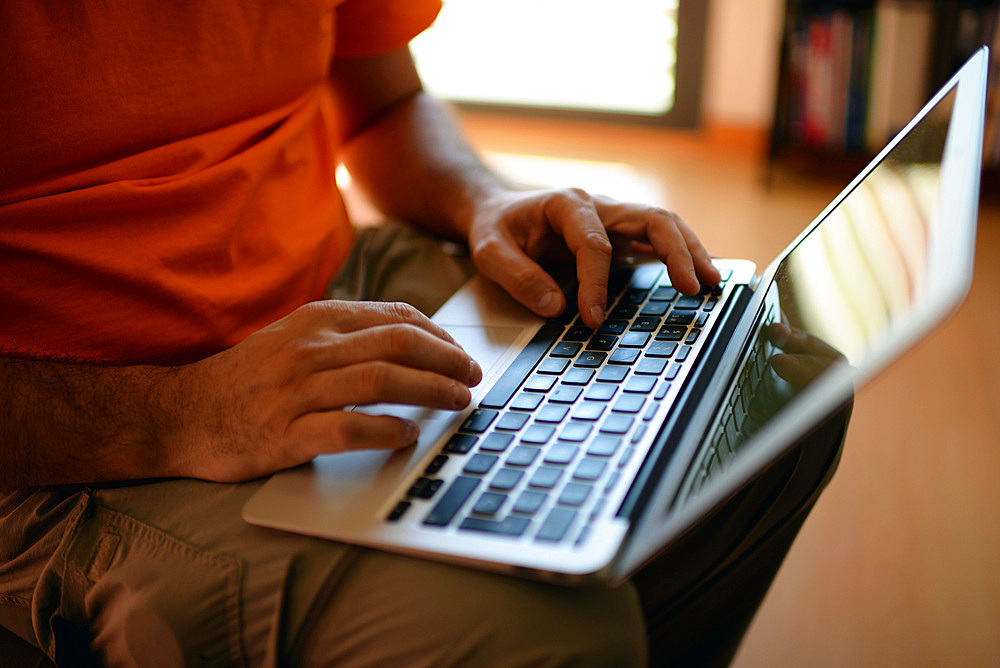 Young man using laptop computer at home