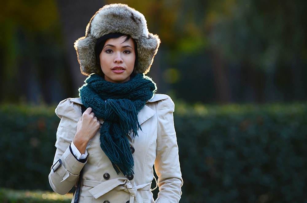 Young eurasian woman poses with a russian hat