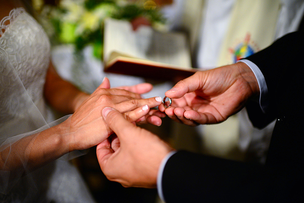 Couple exchange rings during wedding ceremony