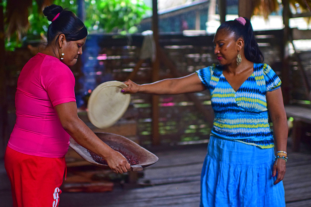 Virgilia and Kathiana preparing natural cacao drink at Bribri tribe house, A day with the Bribri, indigenous people in Lim?n Province of Costa Rica,