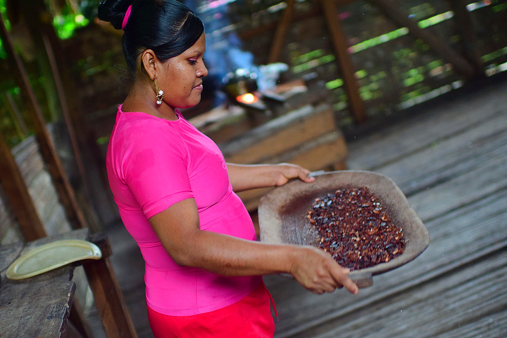 Kathiana helps prepare natural cacao drink at Bribri tribe house, A day with the Bribri, indigenous people in Lim?n Province of Costa Rica,