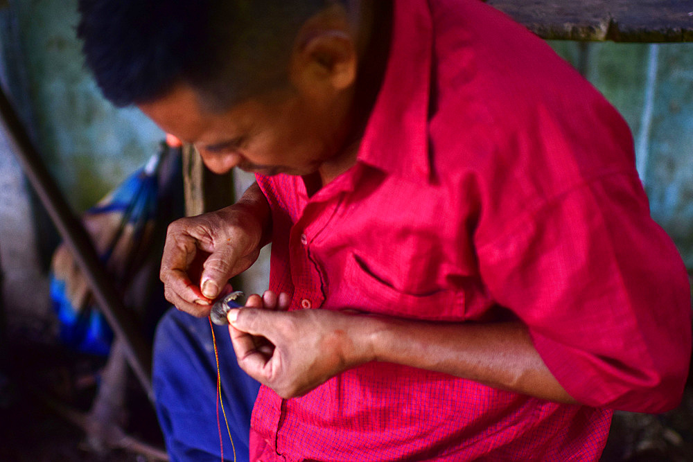 Catato L?pez, Bribri man working on handmade necklace, A day with the Bribri, indigenous people in Lim?n Province of Costa Rica