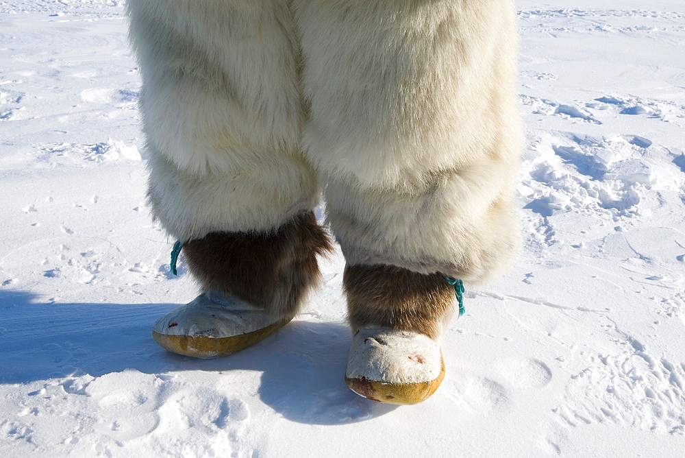 Legs of a young boy in Gojahaven, an Inuit settlement in the far north of Canada.