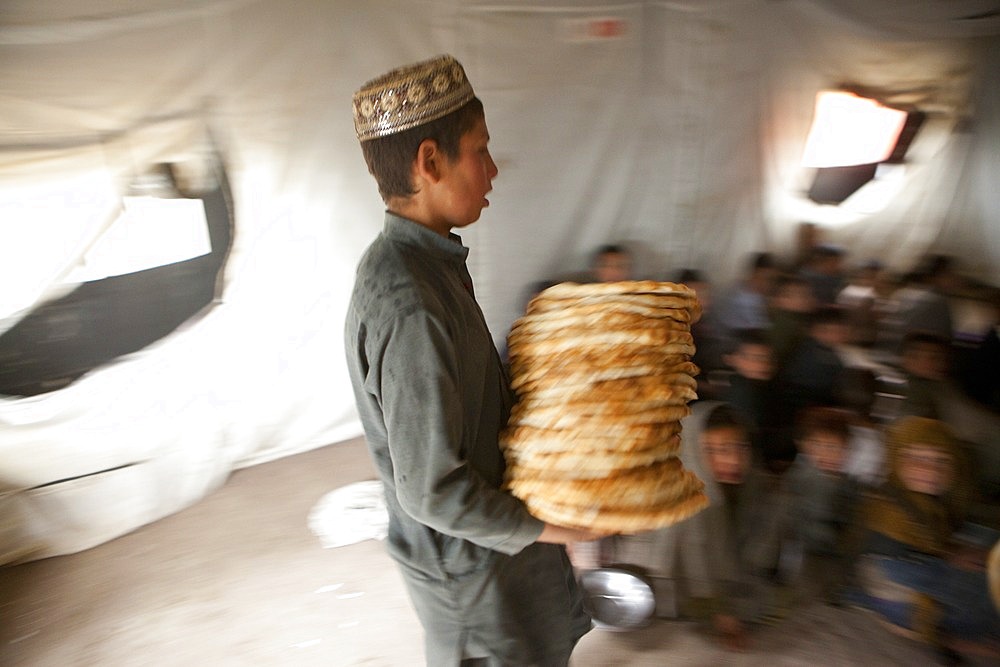 Afghan student gets food at school.