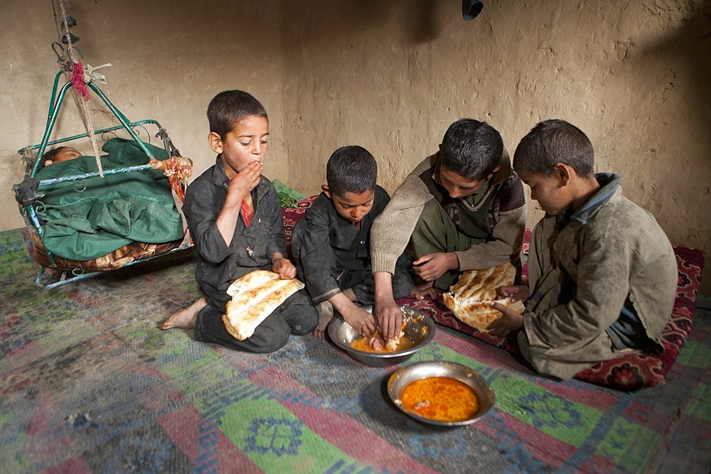 Afghan student gets food at school.