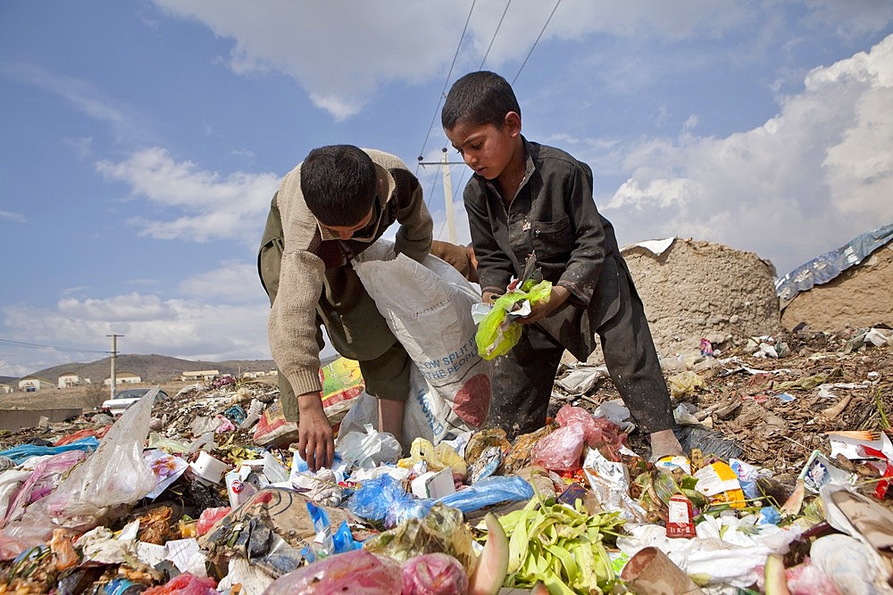 many children earn an income bt collecting plastic among rubbish, Kabul,