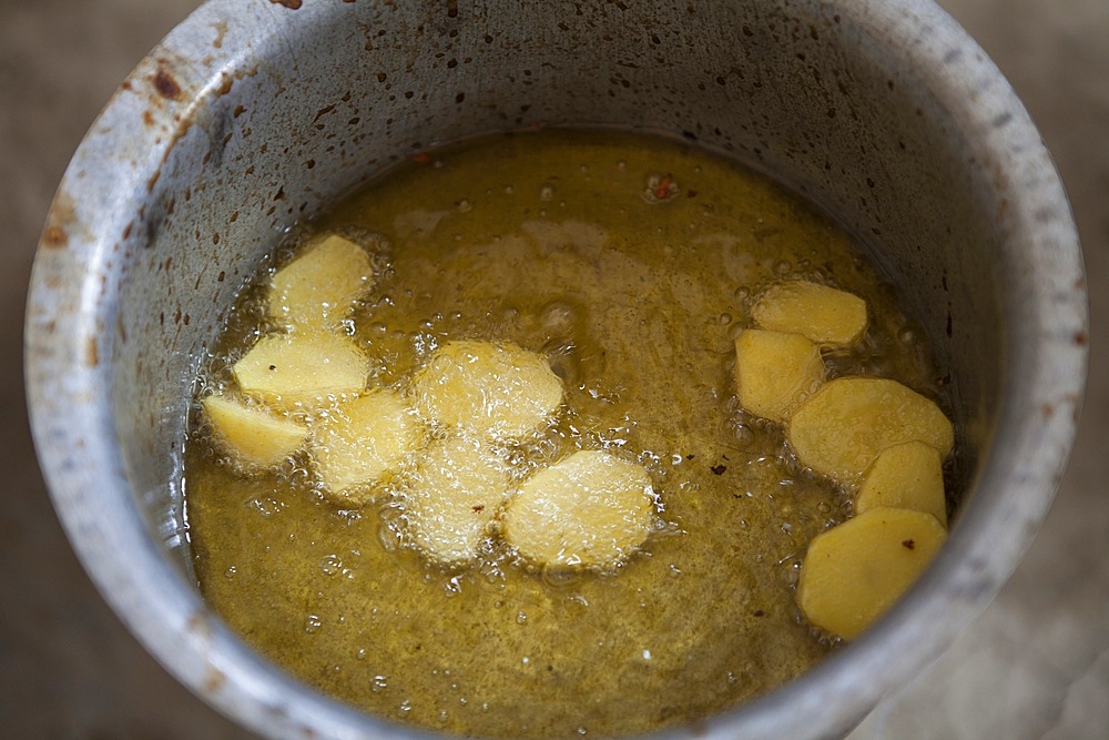 Afghan refugees preparing a potatoe meal, Afghanistan