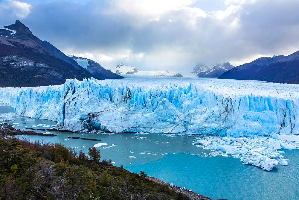 Perito Moreno Glacier and Lago Argentino in Los Glaciares National Park near El Calafate, Argentina.  A UNESCO World Heritage Site in the Patagonia region of South America.  At right is Cordon Reichert with the peak of Cerro Moreno at left.