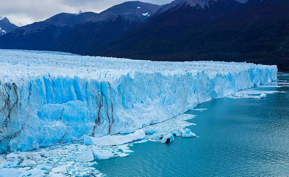 Perito Moreno Glacier and Lago Argentino in Los Glaciares National Park near El Calafate, Argentina.  A UNESCO World Heritage Site in the Patagonia region of South America.  At right is Cordon Reichert.