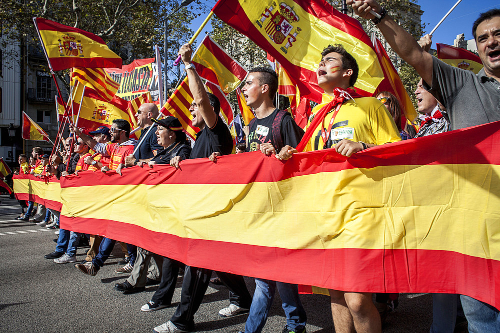 Anti-independence Catalan protestors carry Spanish flags and catalan flags during a demonstration for the unity of Spain on the occasion of the Spanish National Day at Passeig de Gracia, Barcelona on October 12, 2014, Spain