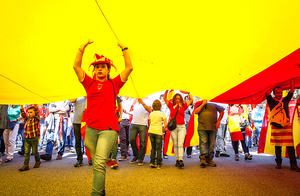 Anti-independence Catalan protestors carry Spanish flag during a demonstration for the unity of Spain on the occasion of the Spanish National Day at Passeig de Gracia, Barcelona on October 12, 2014, Spain