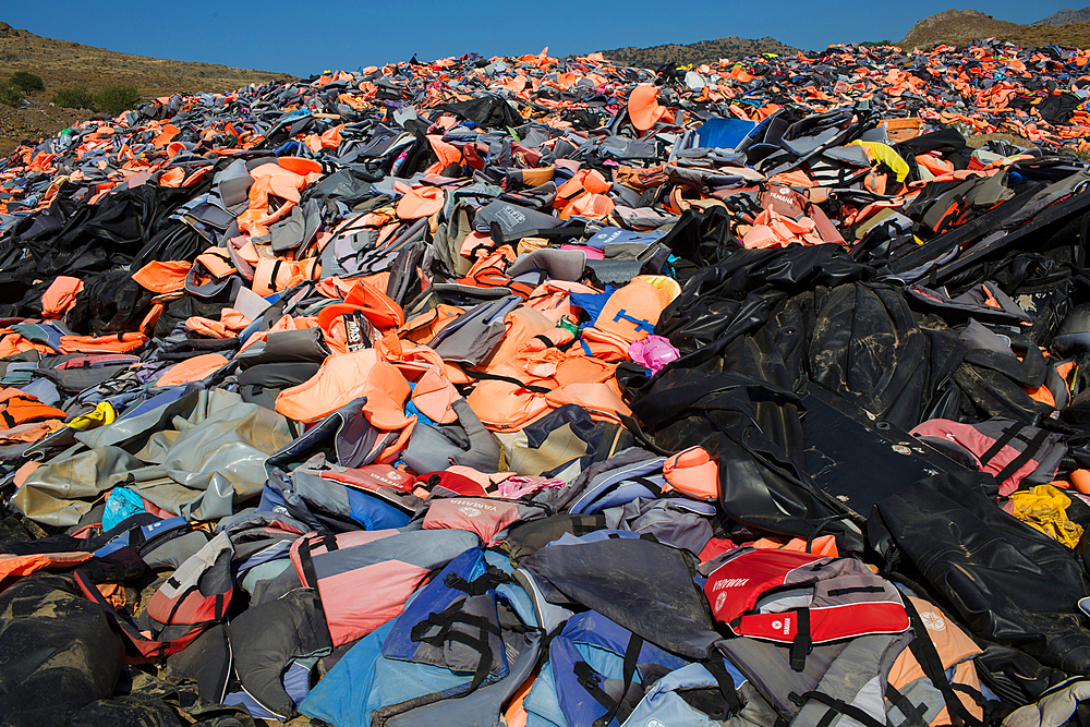 life jackets used by refugees to cross from Turkey to Greece. They are collected and dumped at the waste pit at Lesbos