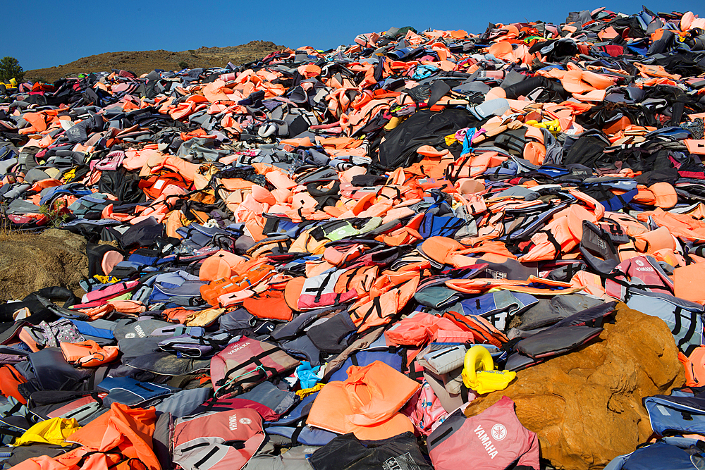 life jackets used by refugees to cross from Turkey to Greece. They are collected and dumped at the waste pit at Lesbos