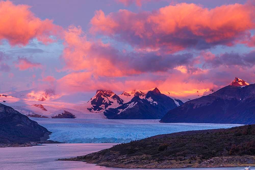 A colorful sunrise over the Perito Moreno Glacier in Los Glaciares National Park near El Calafate, Argentina.  A UNESCO World Heritage Site in the Patagonia region of South America.