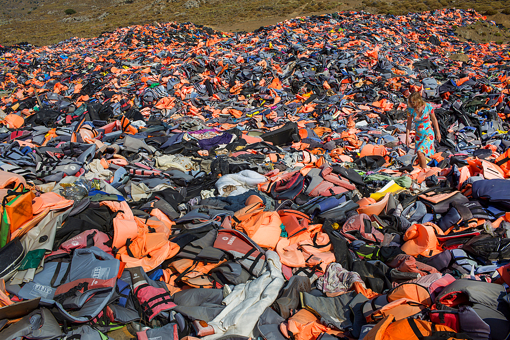 life jackets used by refugees to cross from Turkey to Greece. They are collected and dumped at the waste pit at Lesbos