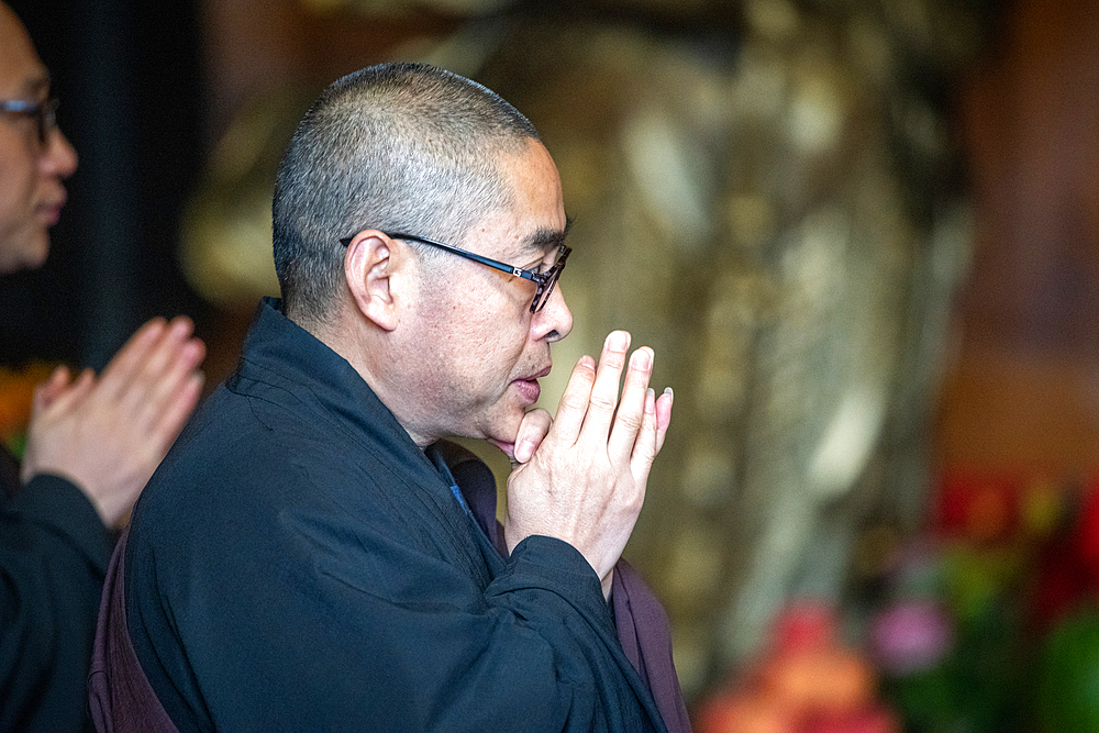 People at Jing'an Temple performing a religious ceremony, Shanghai, China