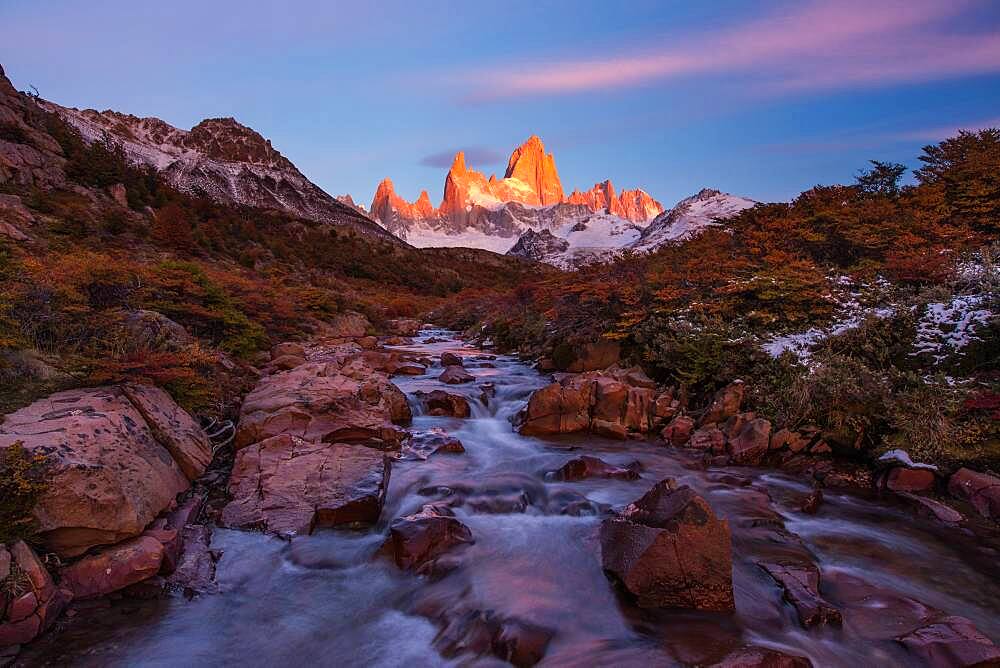 The Fitz Roy Massif at the first light of sunrise.  Los Glaciares National Park near El Chalten, Argentina.  A UNESCO World Heritage Site in the Patagonia region of South America.  Mount Fitz Roy is in the tallest peak in the center.  The creek in the foreground is the Arroyo del Salto.