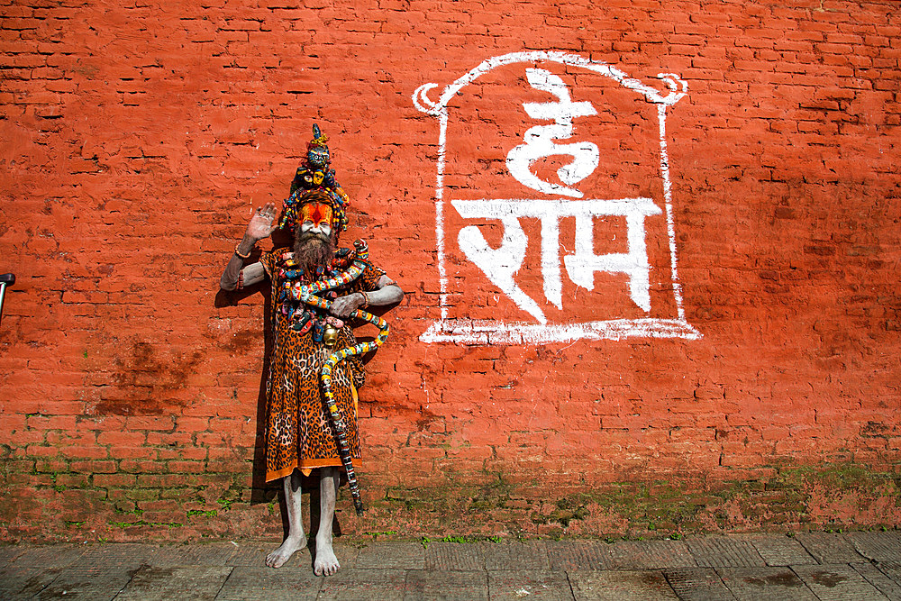 A Saddhu waves from Pashupatinath Temple in Kathmandu, Nepal