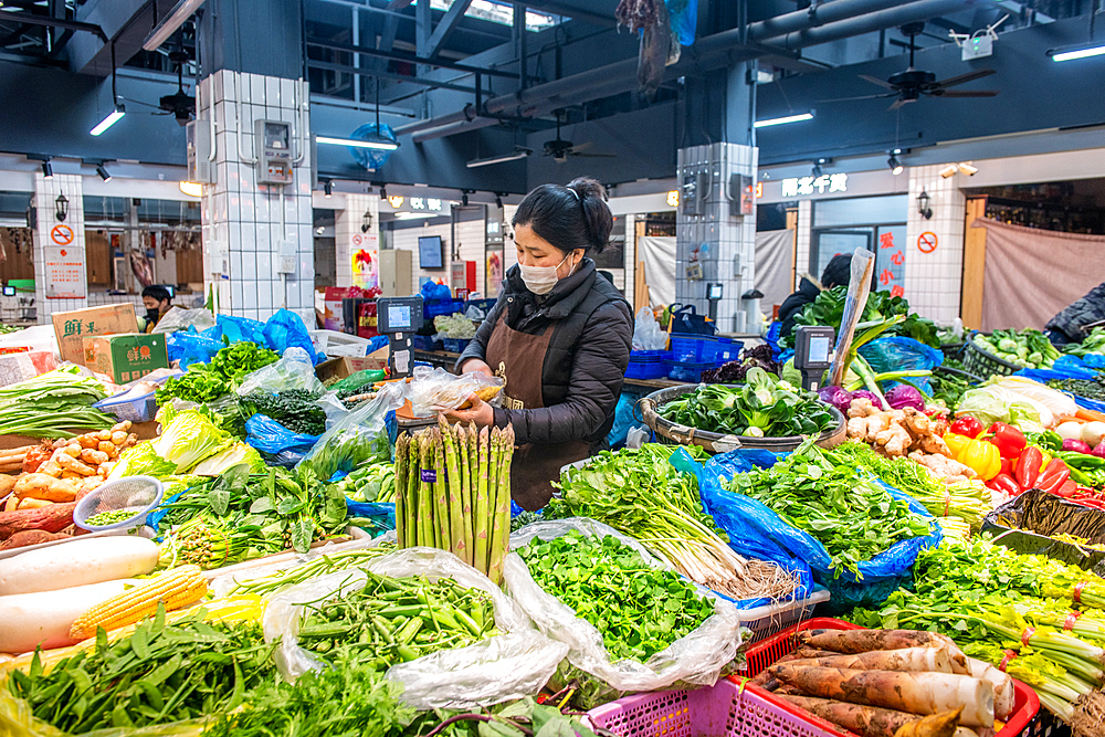 Shanghai, China, 28th Jan 2020, A woman wearing a mask in a market to prevent catching the Coronavirus