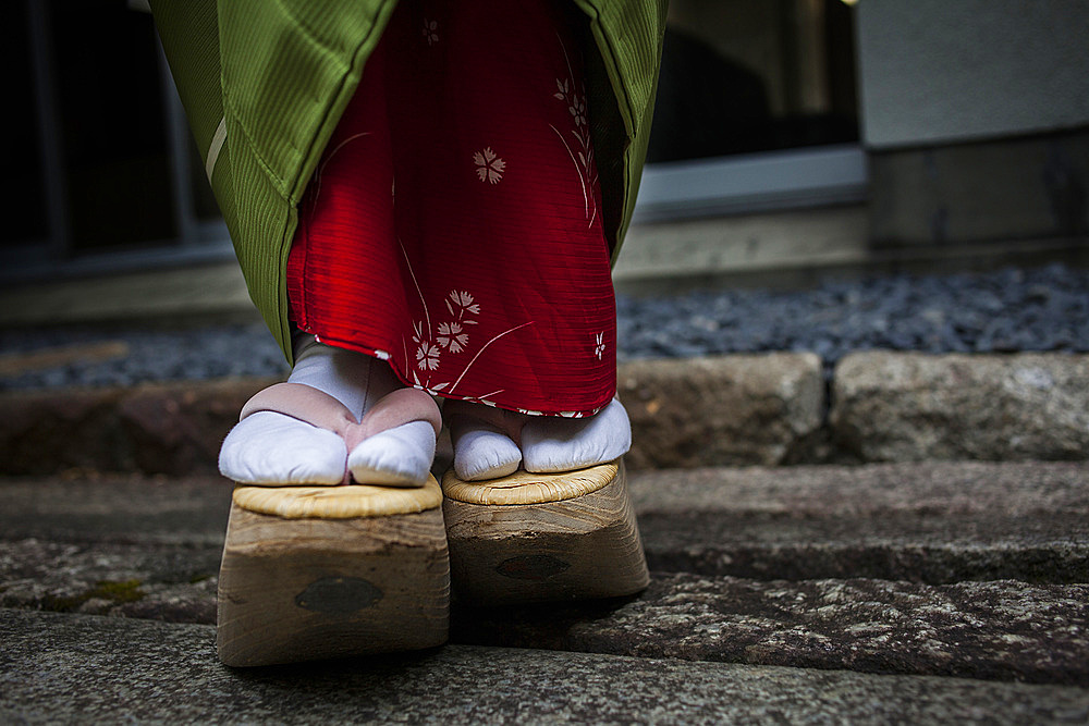 Okobo (tall wooden shoes).Detail of 'maiko' (geisha apprentice) from Ishihatsu tea house (o-chaia).Geisha's distric of Miyagawacho.Kyoto. Kansai, Japan.