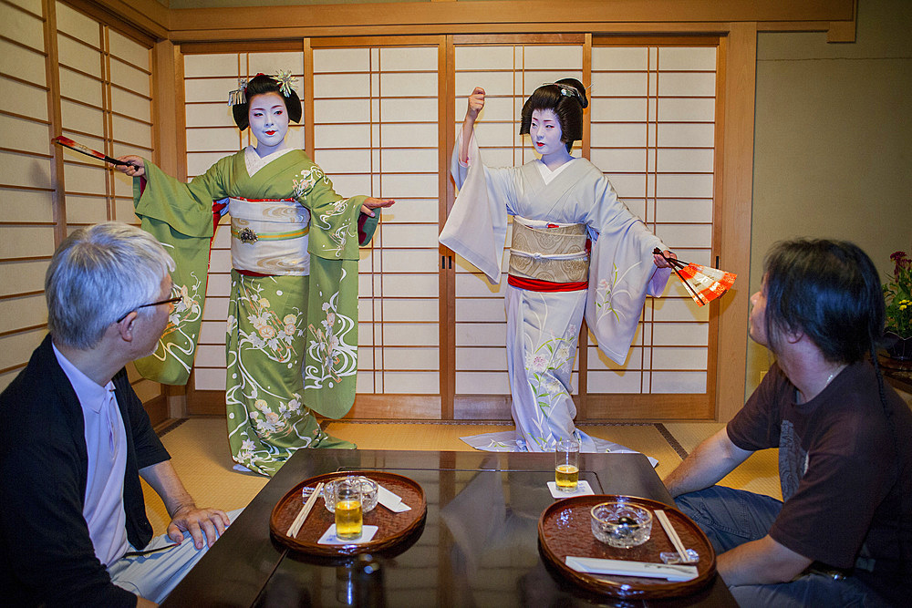 Fukuyu,geisha and Fukukimi,'maiko' (geisha apprentice) workimg in Miyaki tea house (o-chaia).Geisha's distric of Miyagawacho.Kyoto. Kansai, Japan.