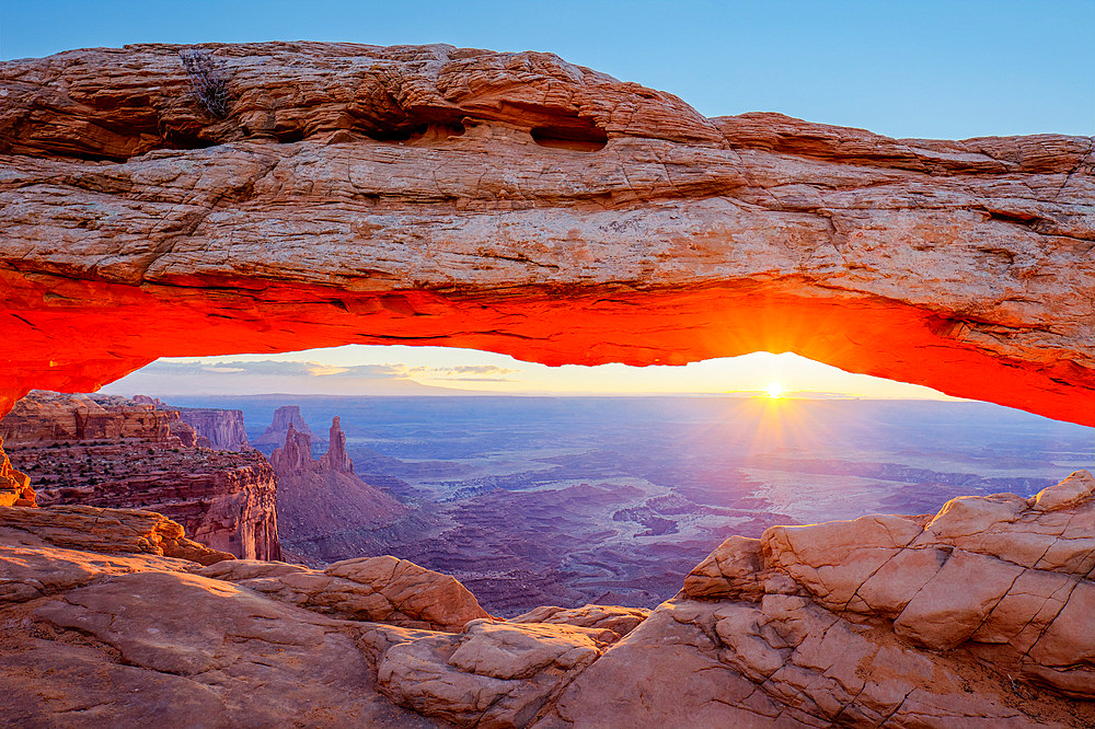 Mesa Arch at sunrise with the Washer Woman Arch, Monster Tower & Airport Tower. Canyonlands National Park, Utah.