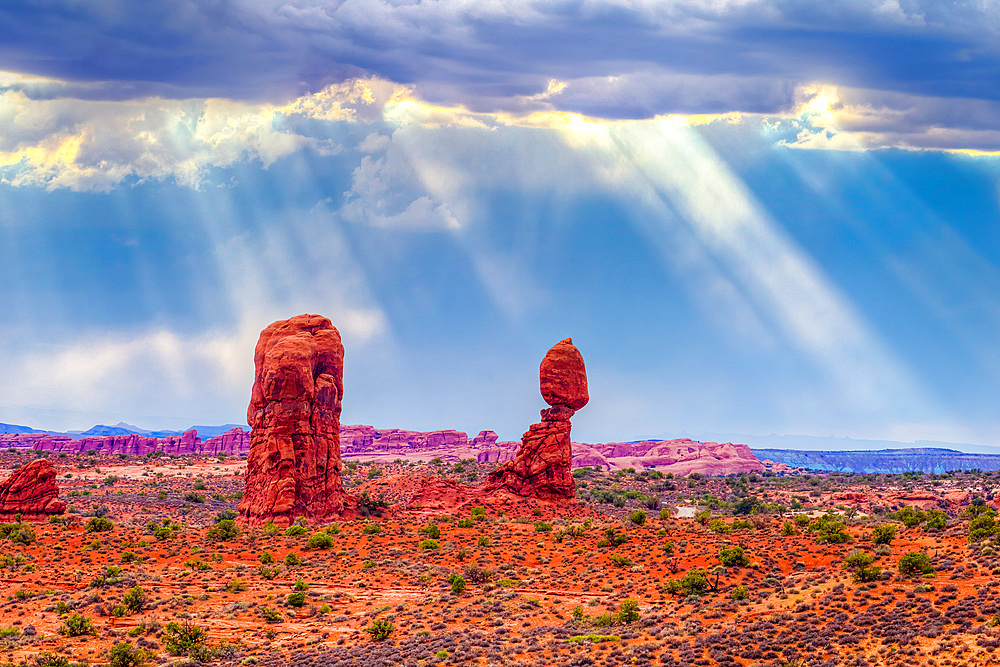 Sun rays in a cloudy morning view of Balanced Rock in Arches National Park, Moab, Utah.