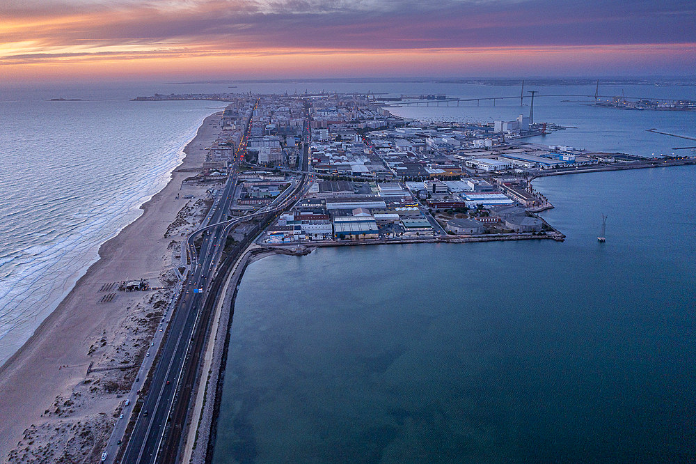 Cadiz in Background. Aerial view of the beach and road CA-33 also called AV V�a Augusta Julia, from San Fernando to Cadiz, Cadiz province, Andalucia, Spain