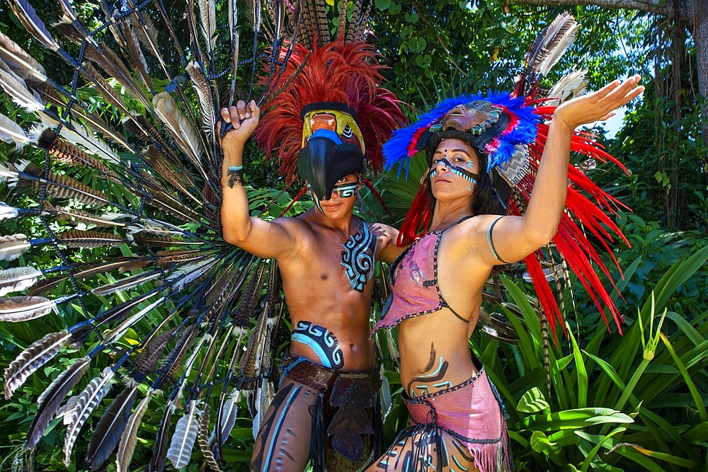 Mexican aztec dress gods at Grand Palladium White Sand Resort and Spa in Riviera Maya, Yucatan Peninsula, Quintana Roo, Caribbean Coast, Mexico. 

Aztec clothing was generally loose fitting and did not completely cover the body. When the Spanish arrived in Mexico, the people were surprised to see them in their full armour, with only their faces exposed.

Aztec clothes were generally made of cotton (which was imported) or ayate fiber, made from the Maguey Cactus (also called the Century Plant or American Aloe). Women would weave the fibers into clothing, a task girls were taught as young teenagers. Because of their vast trading network, the Aztecs were able to make use of a beautiful array of dyes, creating the brilliant